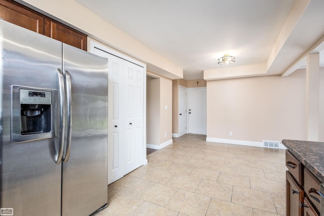 33519 Groth Ave, Sterling Heights, MI 48312 - kitchen featuring stainless steel fridge with ice dispenser, baseboards, and dark stone countertops