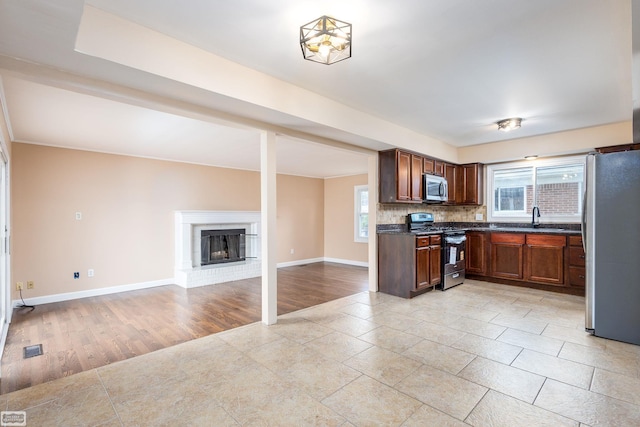 33519 Groth Ave, Sterling Heights, MI 48312 - kitchen featuring appliances with stainless steel finishes, a sink, dark countertops, and healthy amount of natural light