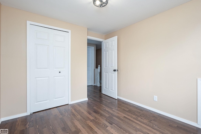 33519 Groth Ave, Sterling Heights, MI 48312 - unfurnished bedroom with dark wood-style flooring, baseboards, and a closet