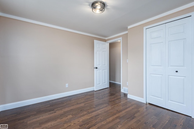 33519 Groth Ave, Sterling Heights, MI 48312 - unfurnished bedroom with dark wood-style flooring, baseboards, a closet, and ornamental molding