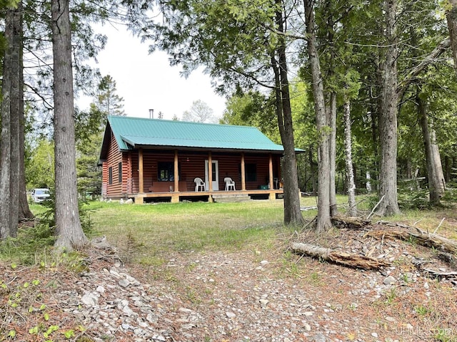 14520 7th Rd, Garden, MI 49835 - view of front of home with a porch, faux log siding, and metal roof