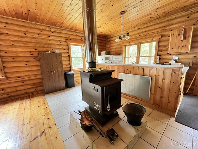 14520 7th Rd, Garden, MI 49835 - kitchen featuring log walls, wooden ceiling, open floor plan, light wood-style floors, and decorative light fixtures