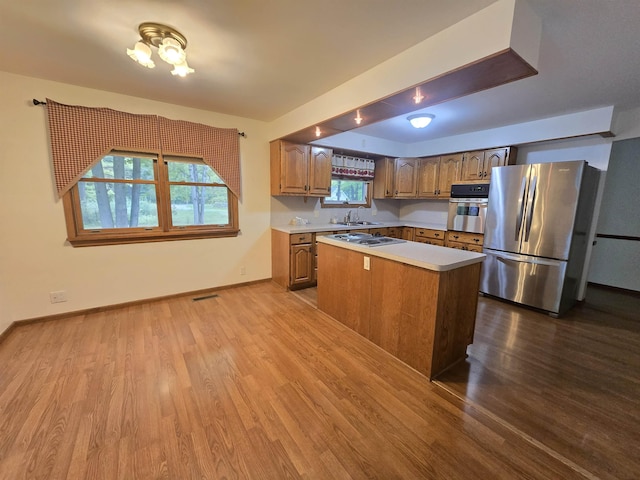 479 S Meridian Rd, Midland, MI 48640 - kitchen with stainless steel appliances, dark wood finished floors, light countertops, a sink, and a kitchen island