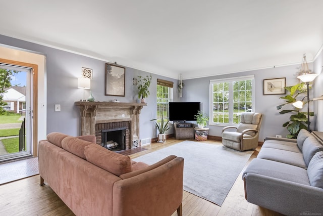 3106 Winifred St, Wayne, MI 48184 - living area featuring wood-type flooring, crown molding, and a brick fireplace