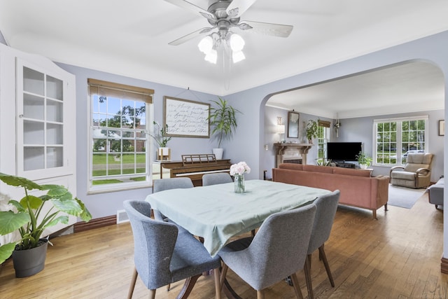 3106 Winifred St, Wayne, MI 48184 - dining room featuring arched walkways, hardwood / wood-style flooring, and a ceiling fan