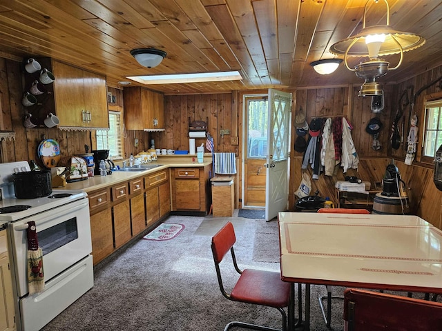 4949 Filter Rd, Harrison, MI 48625 - kitchen with white range with electric cooktop, wood ceiling, wooden walls, plenty of natural light, and brown cabinetry