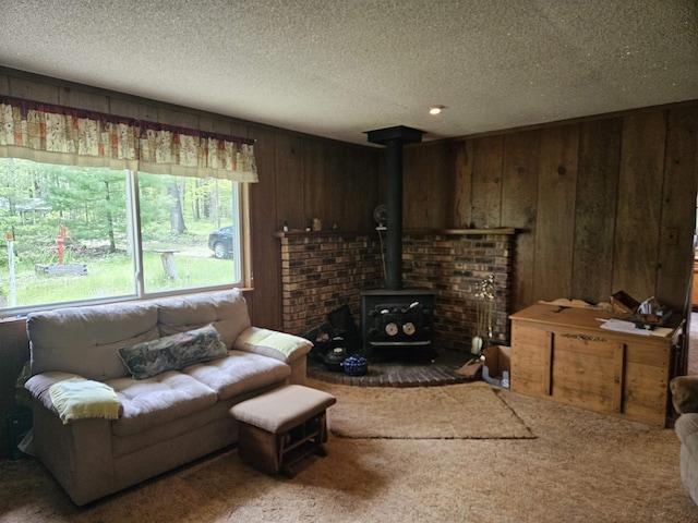 4949 Filter Rd, Harrison, MI 48625 - carpeted living area featuring a wood stove, wooden walls, and a textured ceiling