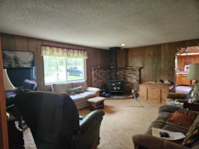 4949 Filter Rd, Harrison, MI 48625 - carpeted living room with a wood stove, wood walls, and a textured ceiling