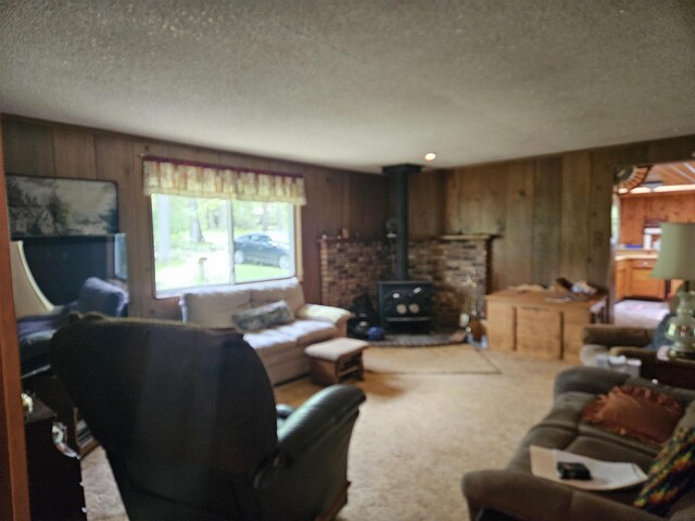 4949 Filter Rd, Harrison, MI 48625 - carpeted living room with a wood stove, wood walls, and a textured ceiling