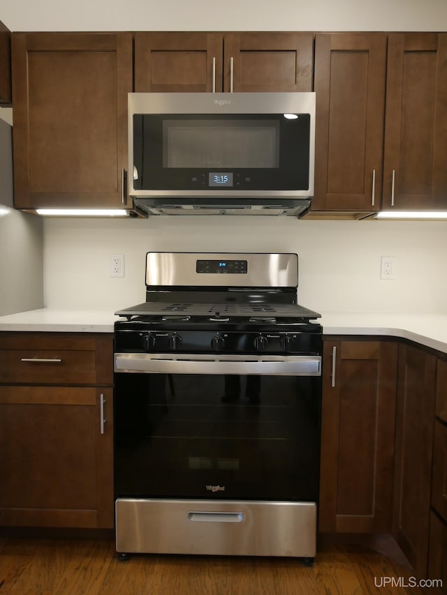 1922 Sherwood Dr, Houghton, MI 49931 - kitchen featuring appliances with stainless steel finishes, light countertops, dark wood-type flooring, and dark brown cabinetry