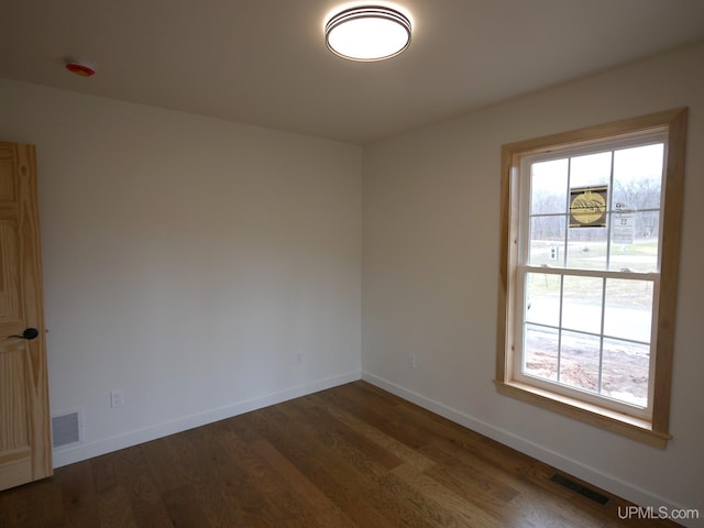 1922 Sherwood Dr, Houghton, MI 49931 - unfurnished room with healthy amount of natural light, baseboards, and dark wood-type flooring