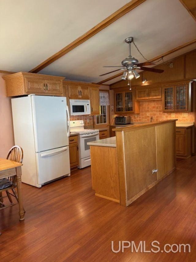 406 3rd Ave, Wakefield, MI 49968 - kitchen with white appliances, lofted ceiling, decorative backsplash, a ceiling fan, and light countertops