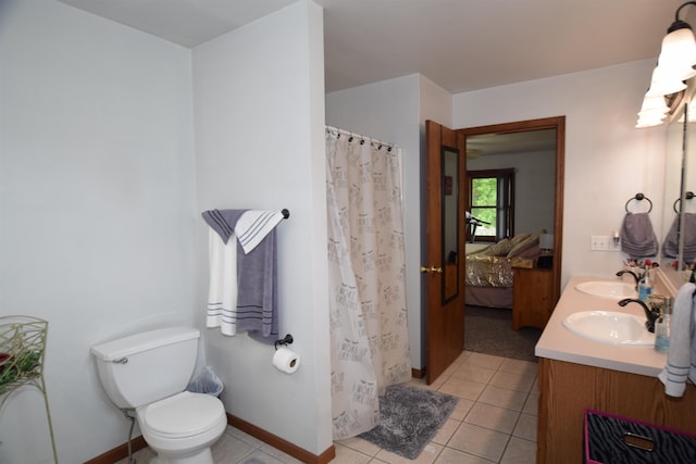 3850 Mando Ct, Coleman, MI 48611 - ensuite bathroom featuring double vanity, tile patterned floors, toilet, a shower with shower curtain, and baseboards
