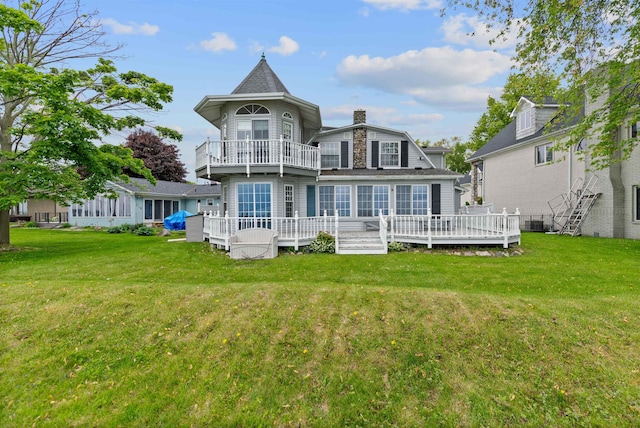 48816 Point Lakeview Dr, Chesterfield Twp, MI 48047 - rear view of house with a balcony, a chimney, a lawn, and a deck
