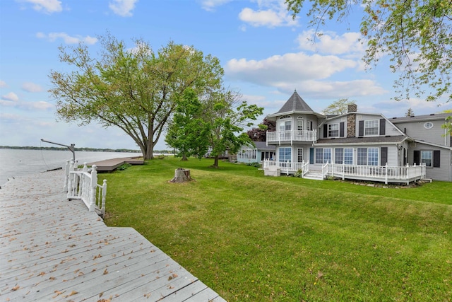 48816 Point Lakeview Dr, Chesterfield Twp, MI 48047 - back of property with a balcony, a yard, a water view, and a chimney