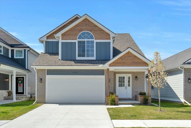 27621 Maryjane Ln E, Chesterfield Twp, MI 48047 - craftsman-style house featuring board and batten siding, concrete driveway, brick siding, and a front yard