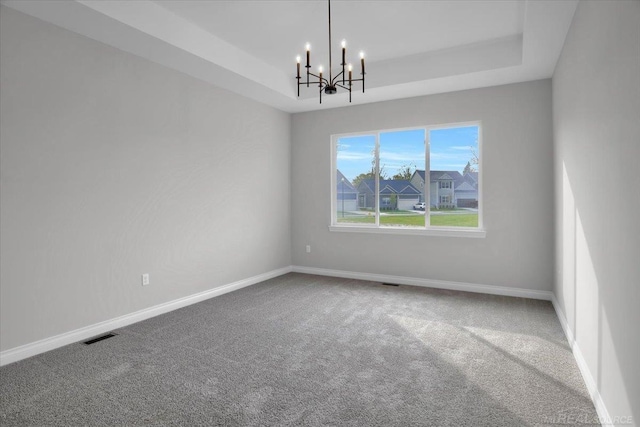 27621 Maryjane Ln E, Chesterfield Twp, MI 48047 - unfurnished room with a tray ceiling, carpet floors, a chandelier, and baseboards