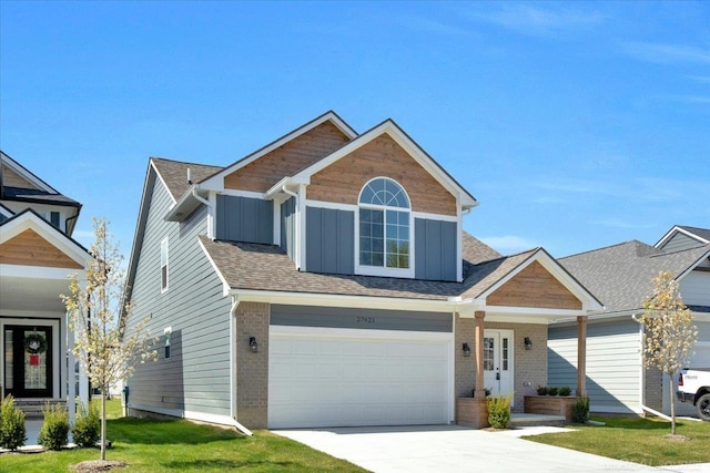 27621 Maryjane Ln E, Chesterfield Twp, MI 48047 - view of front of property with concrete driveway, board and batten siding, an attached garage, a front yard, and brick siding