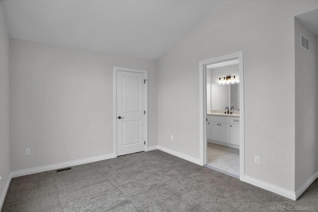 27621 Maryjane Ln E, Chesterfield Twp, MI 48047 - unfurnished bedroom with carpet flooring, vaulted ceiling, baseboards, a sink, and connected bathroom