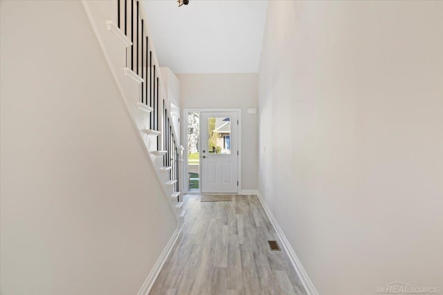 27633 Maryjane Ln E, Chesterfield Twp, MI 48047 - doorway to outside featuring baseboards, light wood-style floors, and stairway