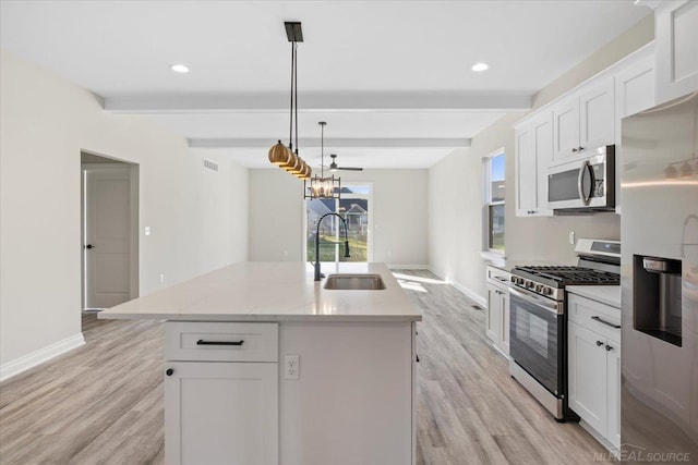 27633 Maryjane Ln E, Chesterfield Twp, MI 48047 - kitchen featuring stainless steel appliances, a sink, beamed ceiling, light wood-style floors, and a kitchen island with sink