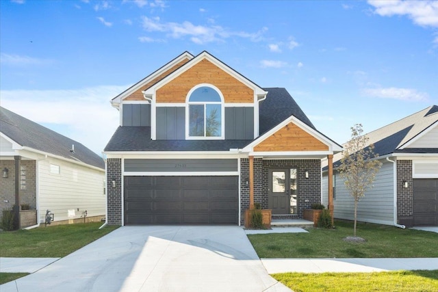 27633 Maryjane Ln E, Chesterfield Twp, MI 48047 - view of front facade with driveway, a garage, a front yard, and board and batten siding