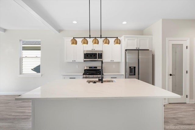 27633 Maryjane Ln E, Chesterfield Twp, MI 48047 - kitchen featuring stainless steel appliances, a sink, white cabinets, a kitchen island with sink, and recessed lighting