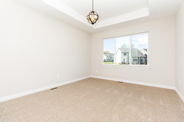 27633 Maryjane Ln E, Chesterfield Twp, MI 48047 - unfurnished room with light carpet, baseboards, a chandelier, and a tray ceiling