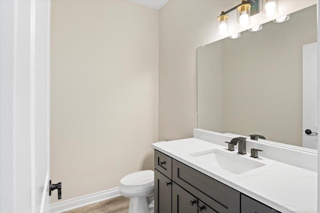 27633 Maryjane Ln E, Chesterfield Twp, MI 48047 - bathroom with vanity, toilet, wood finished floors, and baseboards