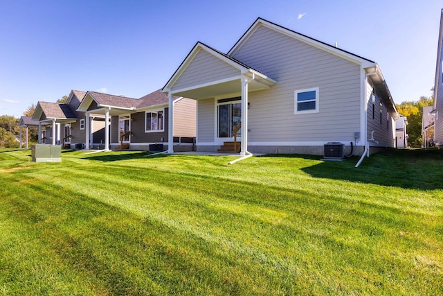 27633 Maryjane Ln E, Chesterfield Twp, MI 48047 - back of house with a lawn and central AC
