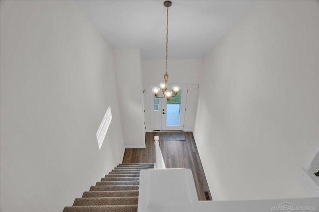 27645 Maryjane Ln E, Chesterfield Twp, MI 48047 - staircase featuring a chandelier, wood finished floors, and baseboards