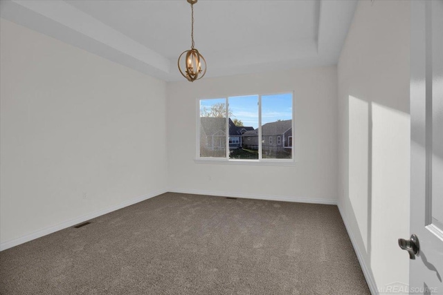 27645 Maryjane Ln E, Chesterfield Twp, MI 48047 - spare room with carpet flooring, a chandelier, baseboards, and a tray ceiling