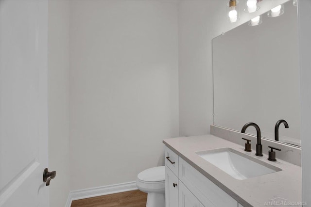 27645 Maryjane Ln E, Chesterfield Twp, MI 48047 - bathroom with vanity, wood finished floors, toilet, and baseboards