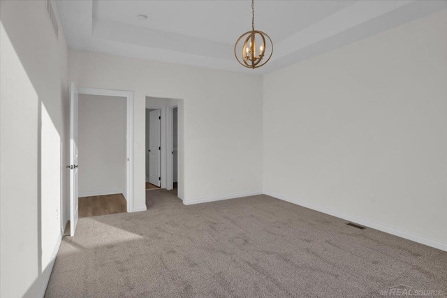 27645 Maryjane Ln E, Chesterfield Twp, MI 48047 - carpeted spare room featuring a chandelier, a tray ceiling, and baseboards
