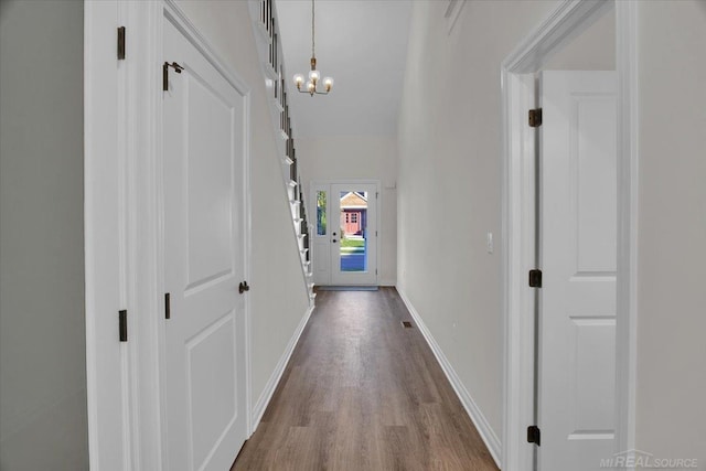 27645 Maryjane Ln E, Chesterfield Twp, MI 48047 - hall featuring a chandelier, dark wood-style floors, and baseboards
