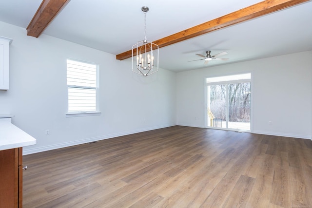 27632 Maryjane Ln E, Chesterfield Twp, MI 48047 - unfurnished dining area featuring beamed ceiling, wood finished floors, a chandelier, baseboards, and a ceiling fan