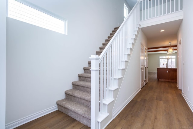 27632 Maryjane Ln E, Chesterfield Twp, MI 48047 - staircase featuring wood finished floors, baseboards, recessed lighting, and a high ceiling