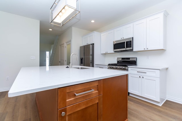 27632 Maryjane Ln E, Chesterfield Twp, MI 48047 - kitchen featuring stainless steel appliances, a sink, light wood-style flooring, recessed lighting, and an island with sink