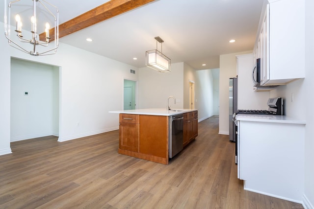 27632 Maryjane Ln E, Chesterfield Twp, MI 48047 - kitchen with appliances with stainless steel finishes, a center island with sink, a chandelier, a sink, and light countertops