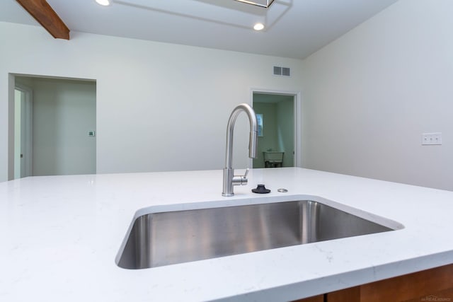 27632 Maryjane Ln E, Chesterfield Twp, MI 48047 - kitchen view of a sink, recessed lighting, light stone countertops, and beamed ceiling