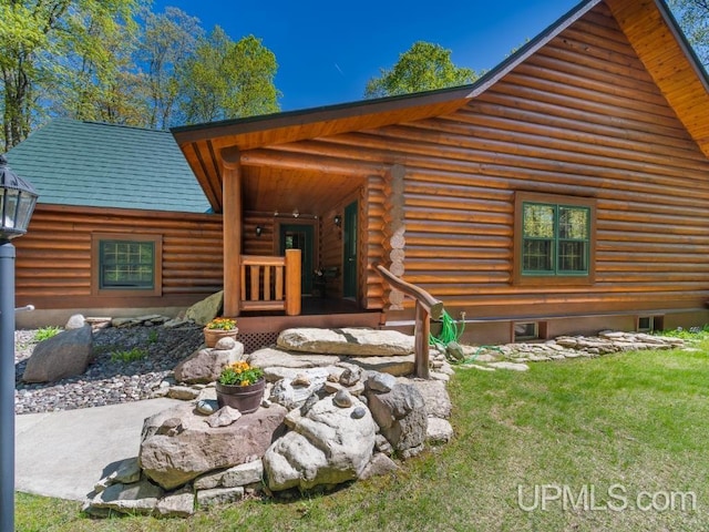 E1849 H44 Hwy, Trenary, MI 49891 - view of front facade with a front yard and log siding