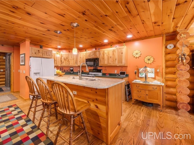 E1849 H44 Hwy, Trenary, MI 49891 - kitchen featuring log walls, a sink, black microwave, light wood finished floors, and wooden ceiling