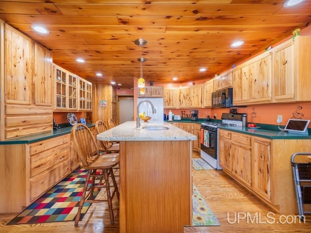 E1849 H44 Hwy, Trenary, MI 49891 - kitchen with gas range, a sink, light wood-style flooring, black microwave, and wood ceiling