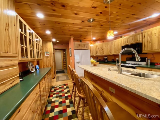 E1849 H44 Hwy, Trenary, MI 49891 - kitchen featuring white appliances, wooden ceiling, light brown cabinetry, recessed lighting, and a breakfast bar area