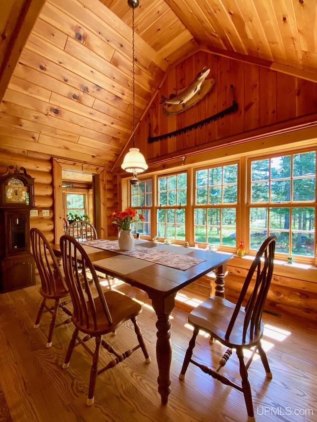 E1849 H44 Hwy, Trenary, MI 49891 - dining area featuring wood ceiling, lofted ceiling, wood-type flooring, log walls, and wood walls