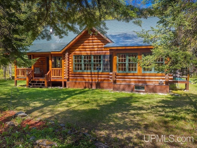 E1849 H44 Hwy, Trenary, MI 49891 - rear view of house featuring log siding, a yard, a shingled roof, and a wooden deck
