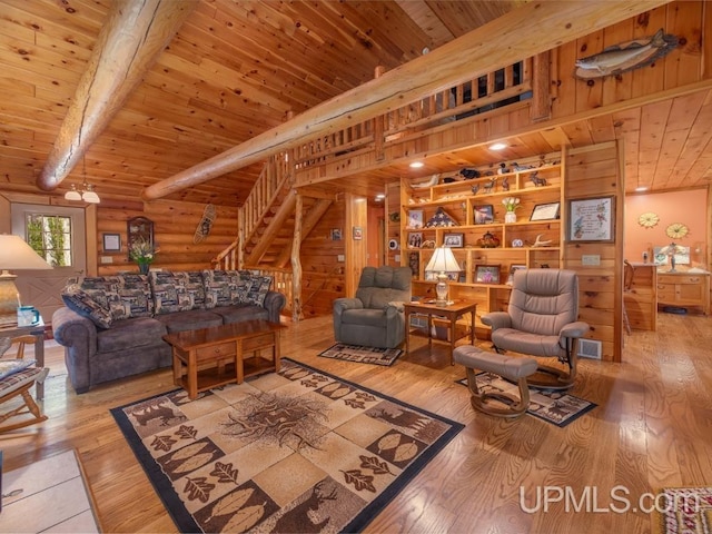 E1849 H44 Hwy, Trenary, MI 49891 - living room featuring wood ceiling with exposed beams, wood finished floors, stairs, and log walls