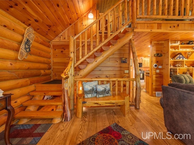E1849 H44 Hwy, Trenary, MI 49891 - stairs with hardwood / wood-style floors, wood ceiling, rustic walls, and high vaulted ceiling