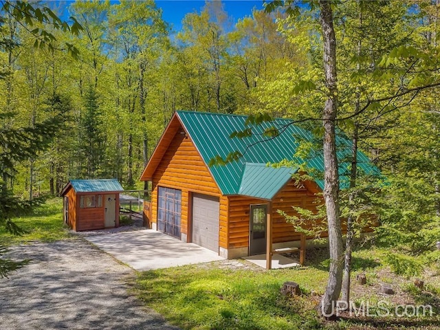 E1849 H44 Hwy, Trenary, MI 49891 - garage featuring a storage unit and a wooded view
