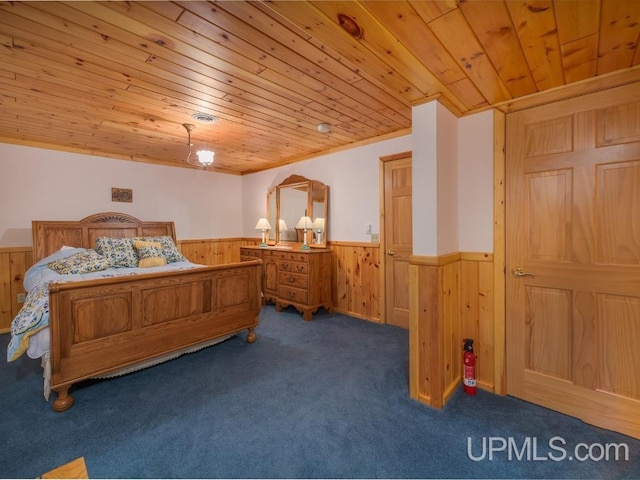 E1849 H44 Hwy, Trenary, MI 49891 - bedroom with wainscoting, wood ceiling, wood walls, and carpet flooring